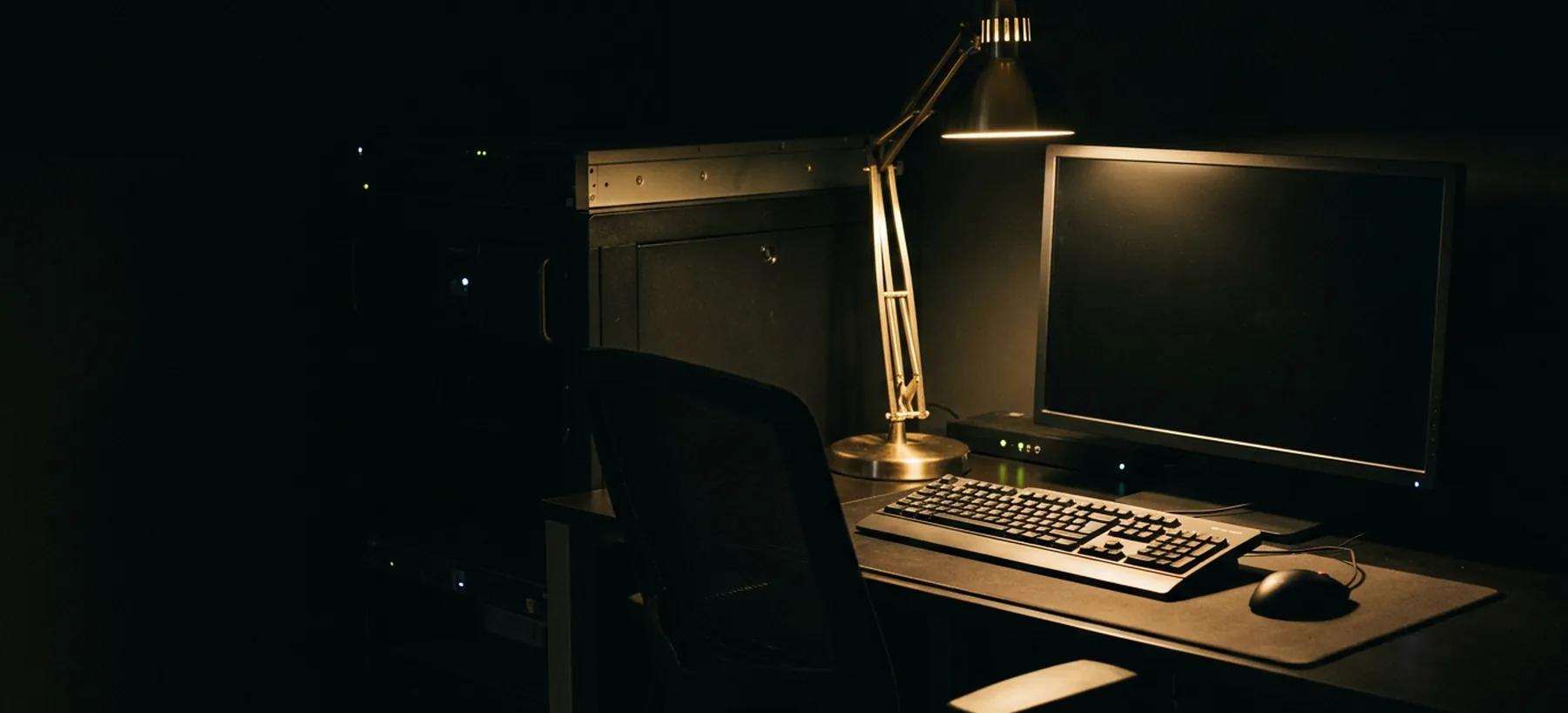 An empty operator desk in a darkened operations room